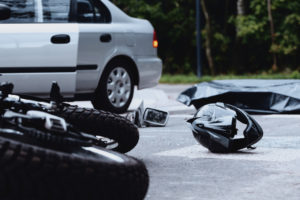 Motorcycle helmet on the street after a fatal accident with a car