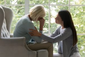 daughter consoling mother after lost of a loved one