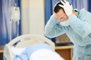 Doctor crying in front of patient