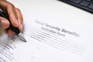 person filling out social security benefits application