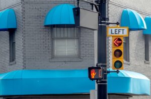 traffic signal in small town showing a red arrow for left handed turns