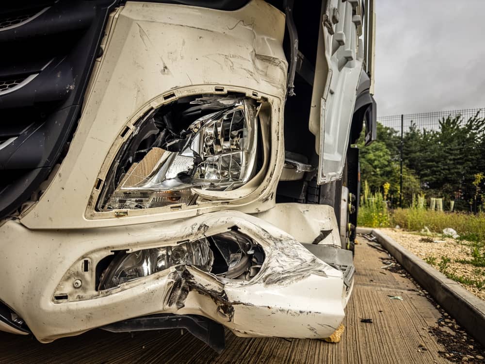 smashed front end of a truck after accident