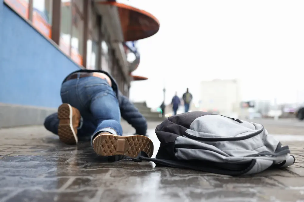 student laying on the ground after slipping and falling